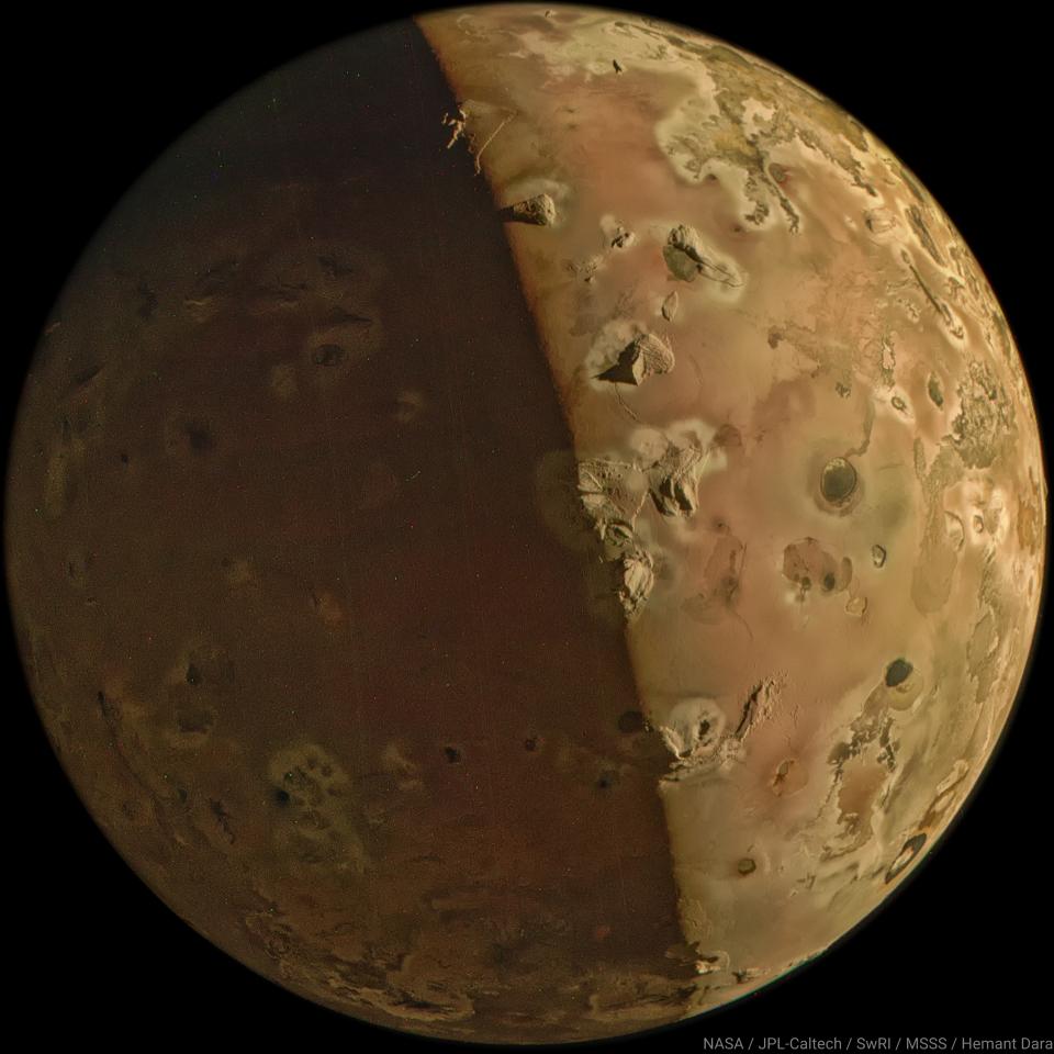 Composite closeup photo of Jupiters moon Io showing relief detail and a shadow line diagonally across the middle